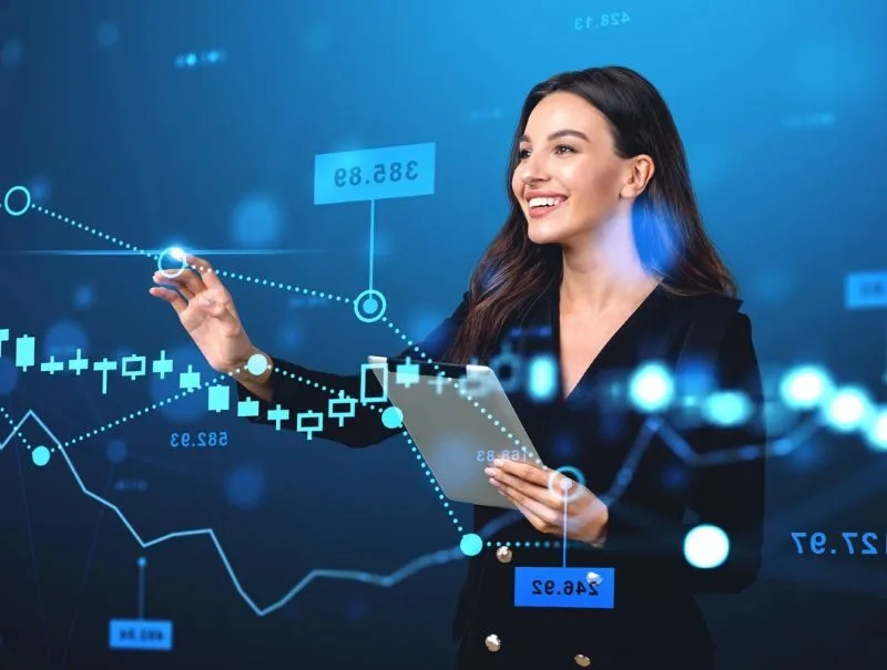 Business woman happily pointing to a graph with rising profits Business woman happily pointing to a graph with rising profits